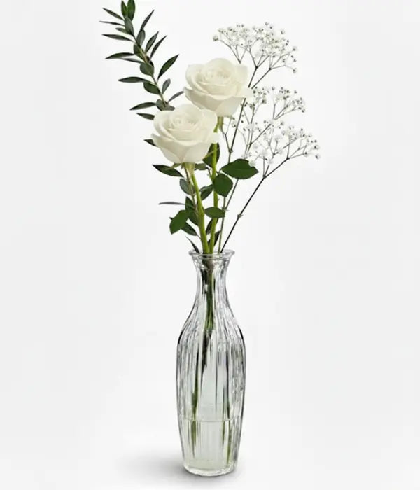 White roses in bud vase from florist
